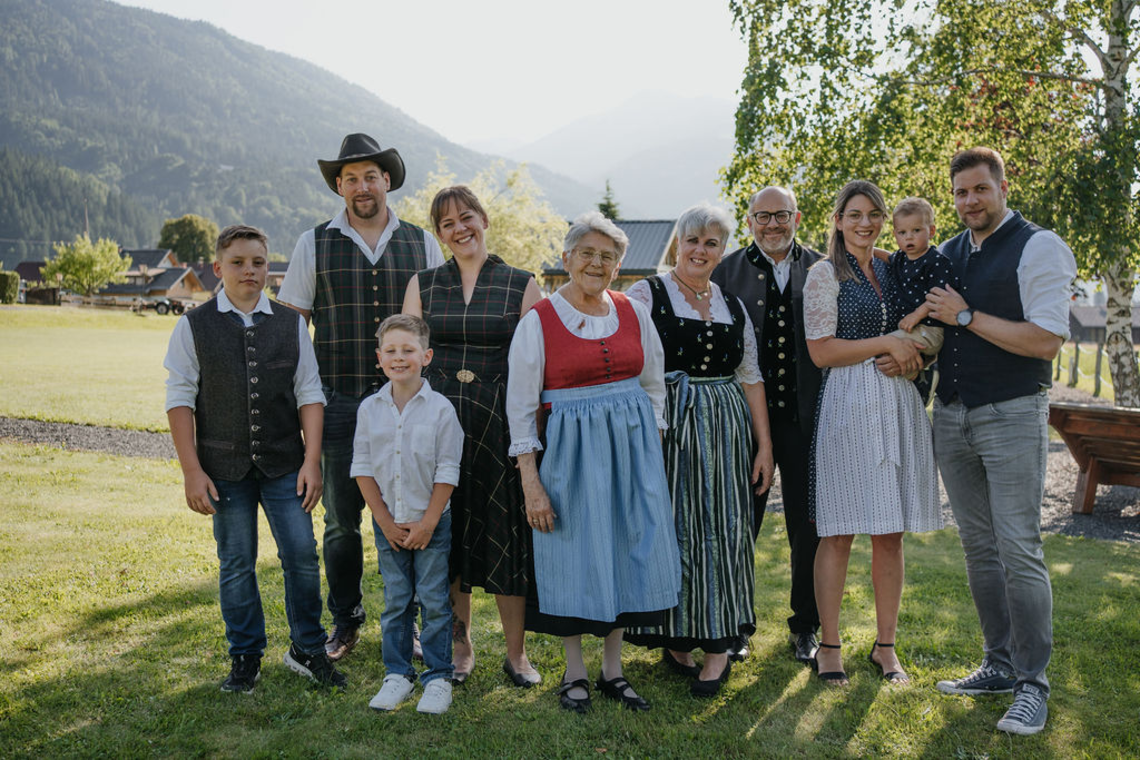 The Zerza family in traditional costume in the garden in front of the house.