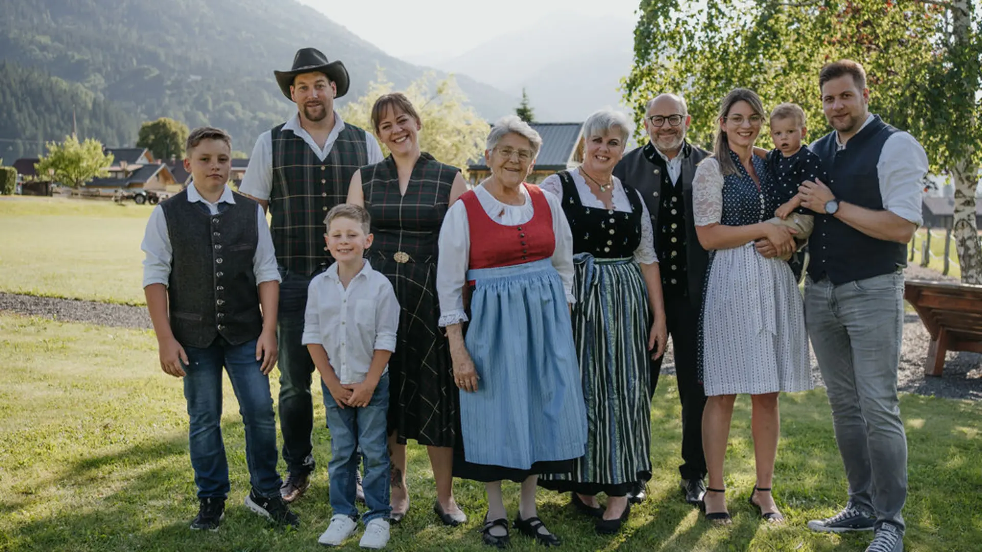 The Zerza family in traditional costume in the garden in front of the house.