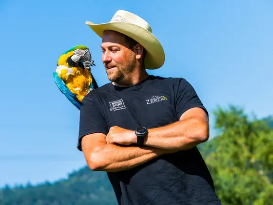 Thomas Zerza with a parrot on his shoulder.