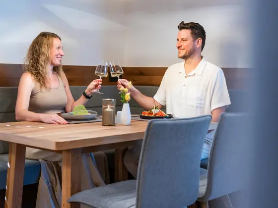 A couple enjoying a glass of wine at the Vista restaurant.
