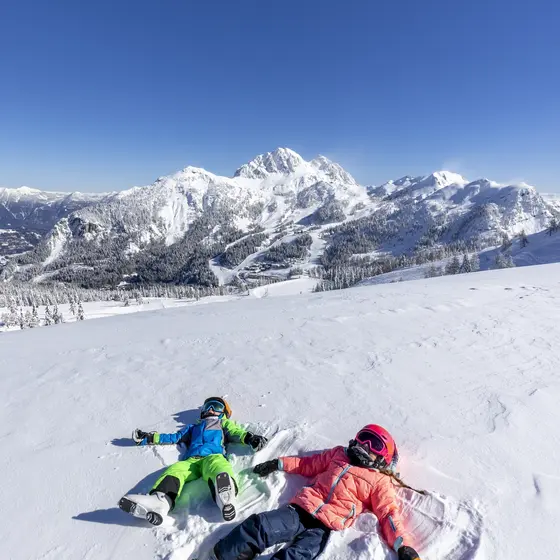 Children making a snow angel (c) Martin Luegger.