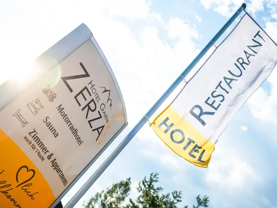 Sign and flag at the entrance to Hotel Garni Zerza.