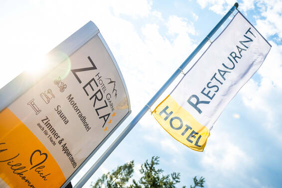 Sign and flag at the entrance to Hotel Garni Zerza.